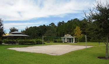 volleyball court with trees and small pavilion in background